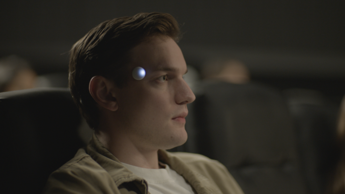 A sleek, compact wearable device named Omi, shown clipped to clothing, highlighting its minimalist design and AI-powered functionality.